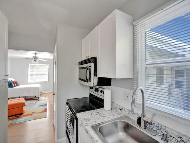 a kitchen with a sink and a stove top oven