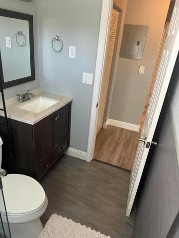 a bathroom with a sink mirror vanity and toilet