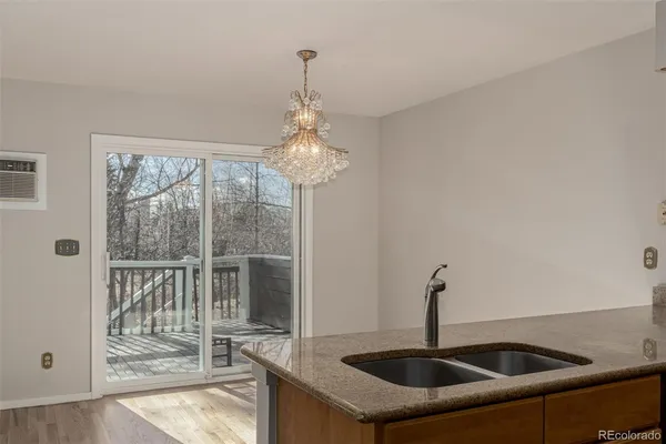 a kitchen with a sink and chandelier