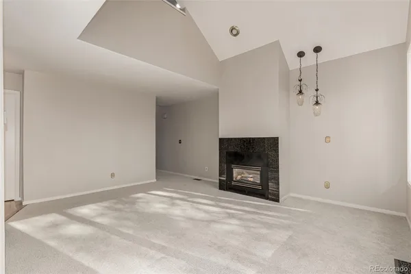 a view of an empty room with a fireplace