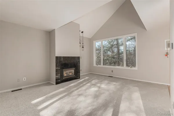a view of empty room with a fireplace