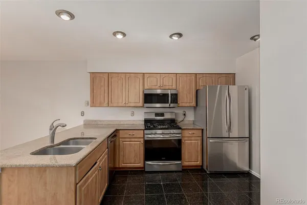 a kitchen with a sink a stove and refrigerator