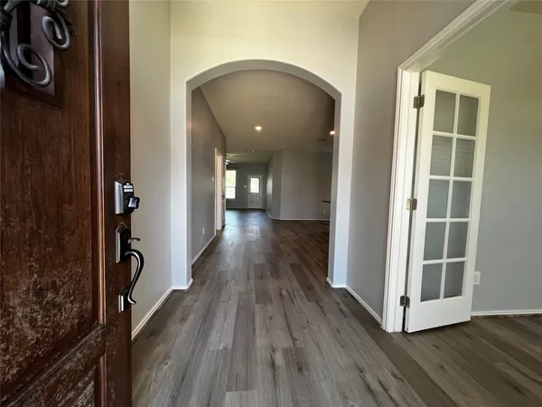 a view of a hallway with wooden floor