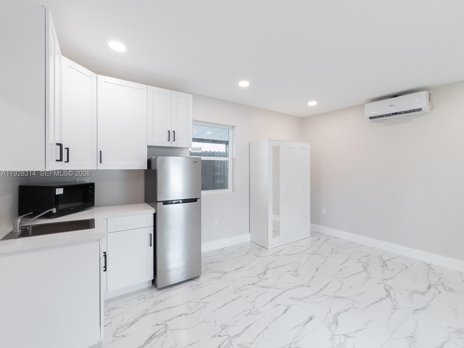 3360 Southwest 24th Terrace, Unit 3362B Miami, FL 33145 - Photo 3 of 15 a kitchen with stainless steel appliances a refrigerator sink and microwave