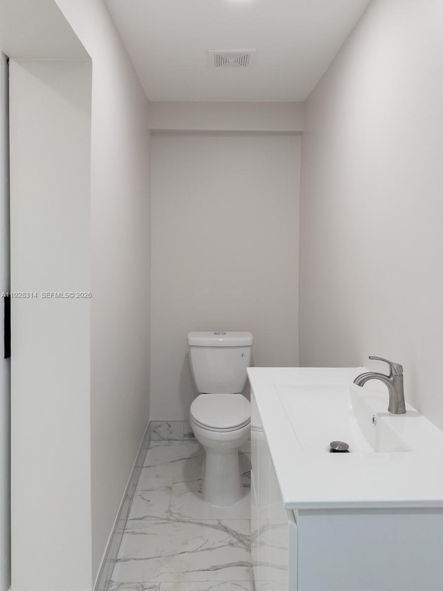 3360 Southwest 24th Terrace, Unit 3362B Miami, FL 33145 - Photo 6 of 15 a white toilet sitting next to a white sink