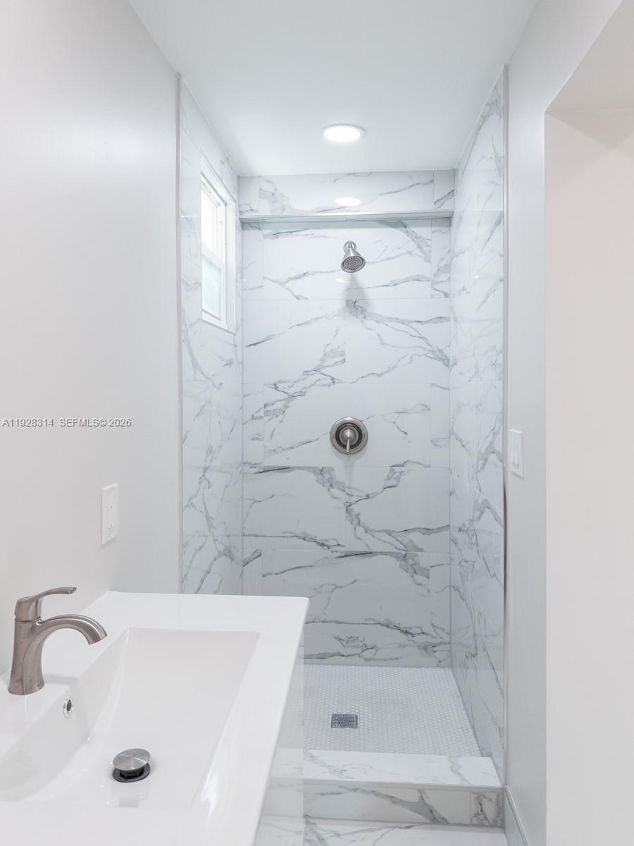 3360 Southwest 24th Terrace, Unit 3362B Miami, FL 33145 - Photo 7 of 15 a bathroom with a sink and a tub