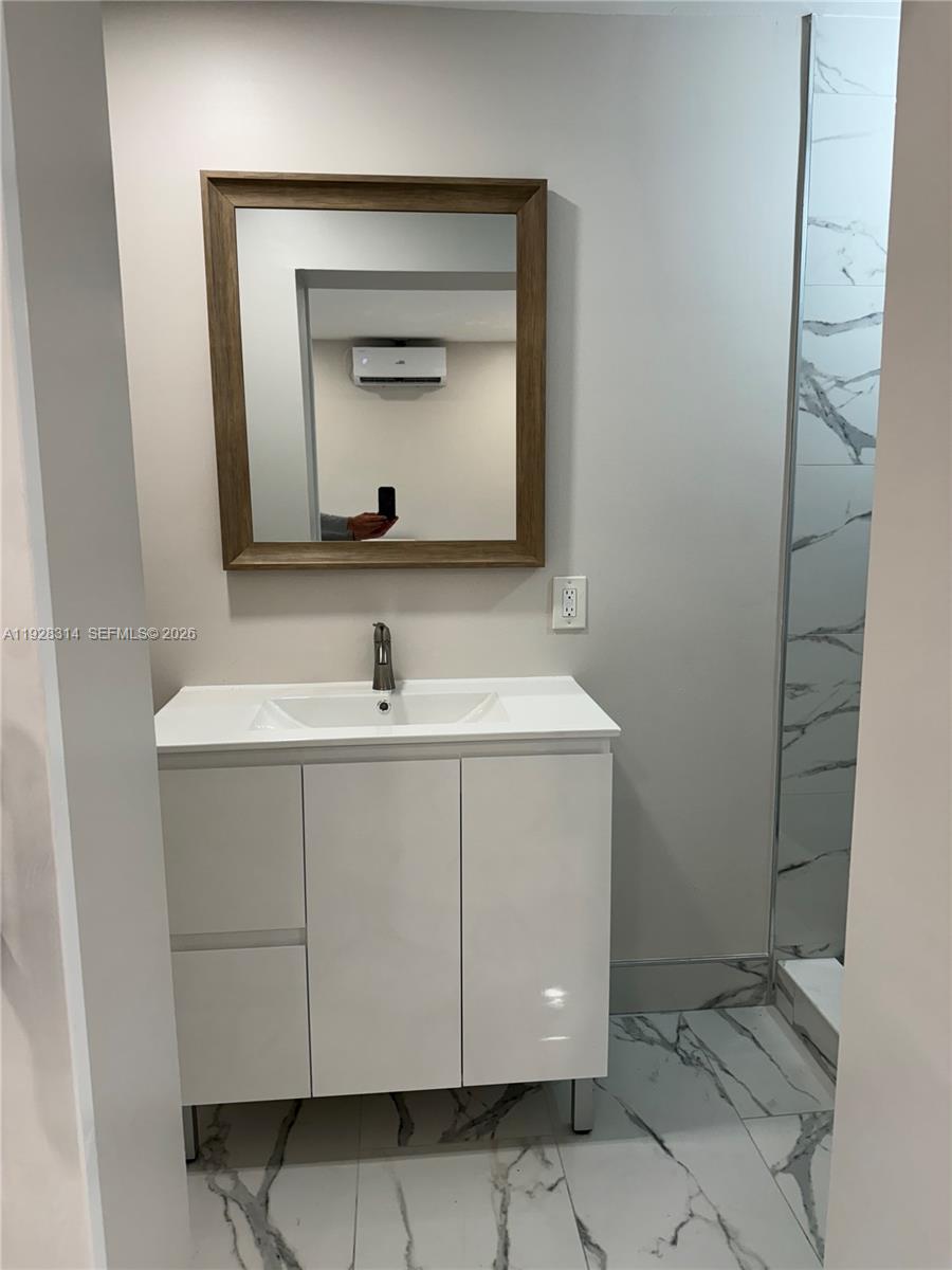 3360 Southwest 24th Terrace, Unit 3362B Miami, FL 33145 - Photo 8 of 15 a bathroom with a sink vanity and mirror