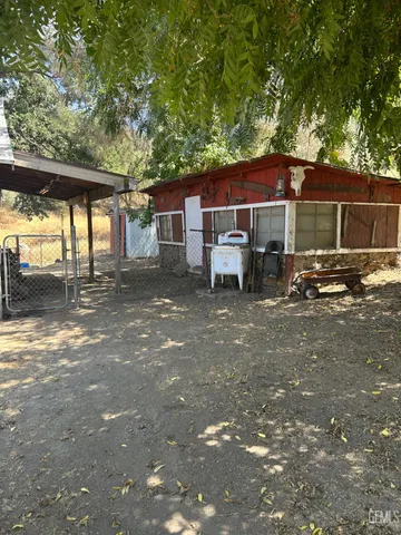a backyard of a house with table and chairs