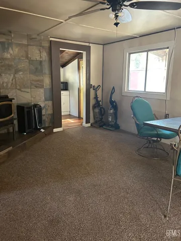 a view of a livingroom with furniture and a window