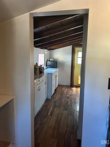 a kitchen with granite countertop a stove a sink and a refrigerator