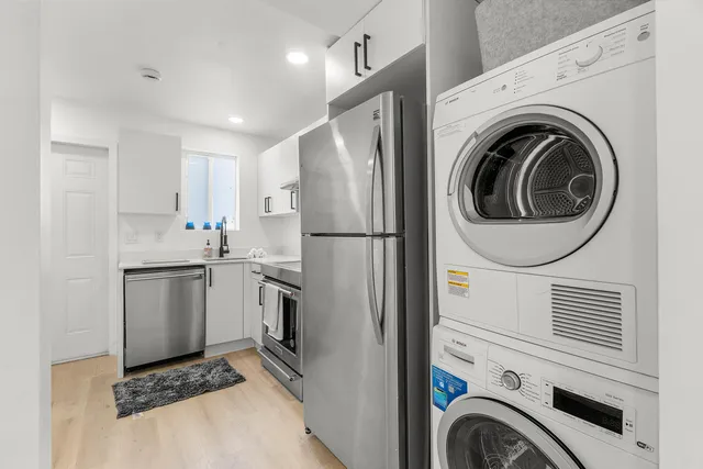 a kitchen with a sink cabinets and stainless steel appliances