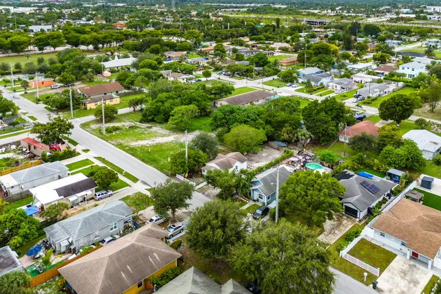 an aerial view of residential houses with outdoor space and street view