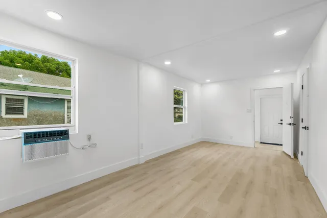 an empty room with windows and entrance