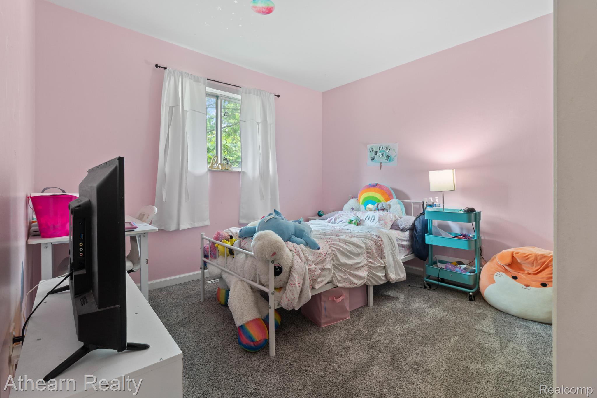 7156 Sharp Road Swartz Creek, MI 48473 - Photo 21 of 32 Carpeted interior room with a window featuring white curtains