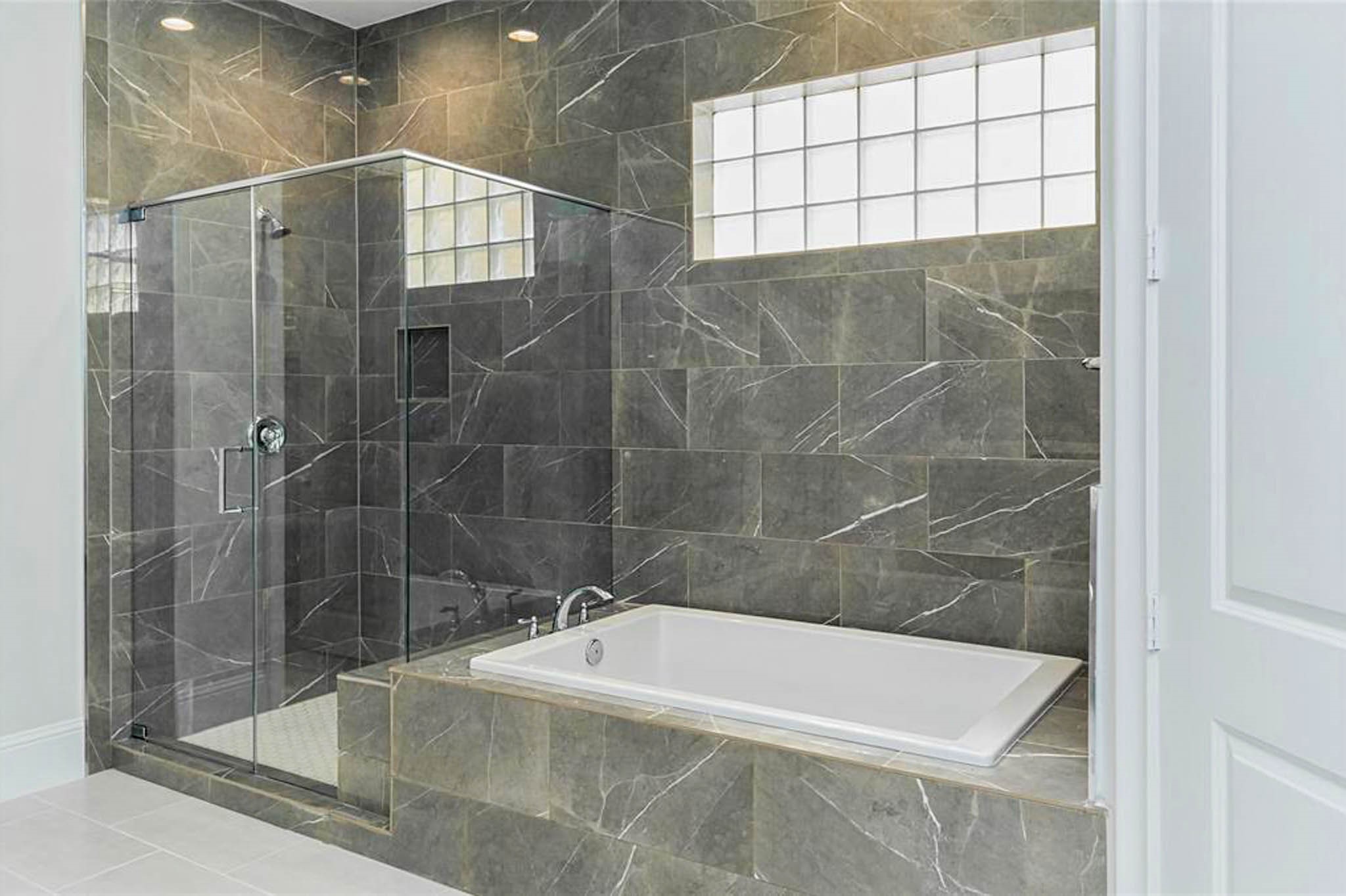 7715 South Fall Run Crossing Houston, TX 77055 - Photo 10 of 22 a bathroom with a bathtub and a shower