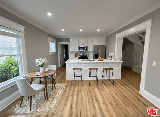 a view of a dining room with furniture and wooden floor
