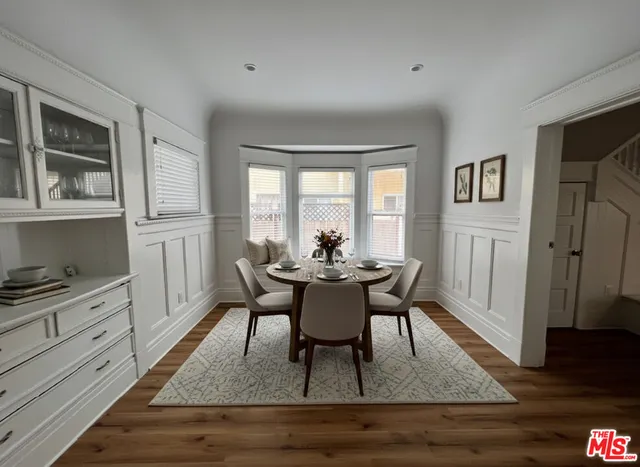 a dining room with furniture and wooden floor