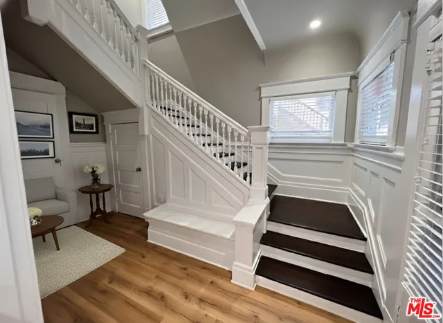 a view of entryway and hall with wooden floor