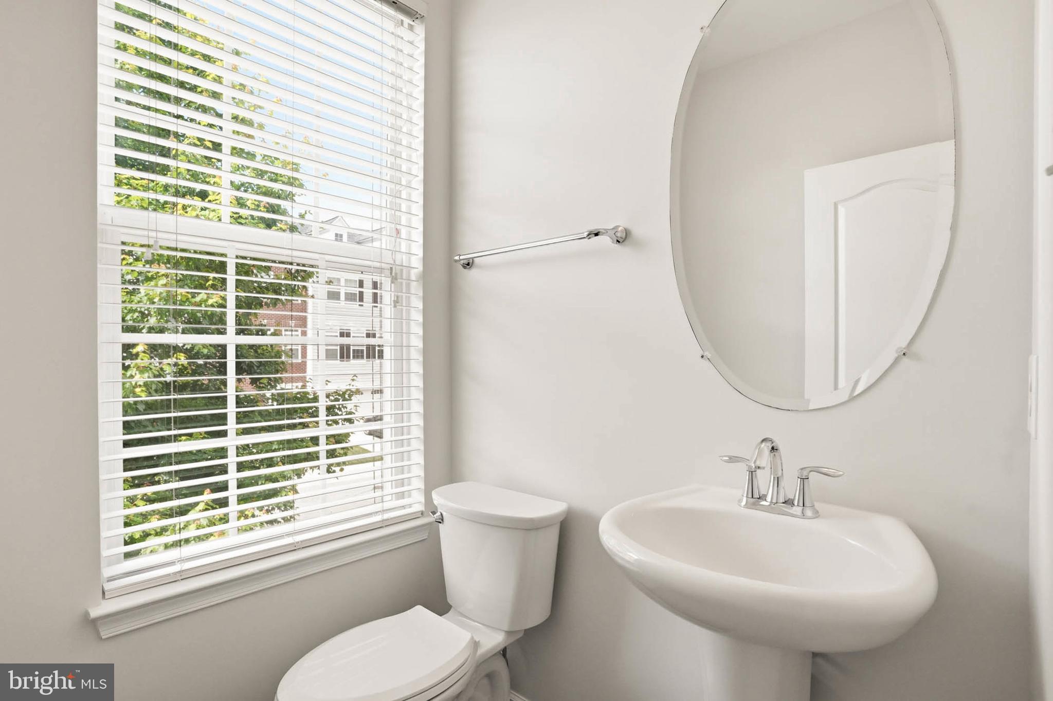 9817 Solar Course Laurel, MD 20723 - Photo 14 of 59 a bathroom with a sink a toilet and a mirror