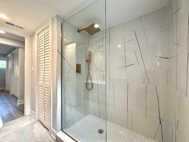 906 Revere Road Glenview, IL 60025 - Photo 12 of 32 a bathroom with a shower and a mirror