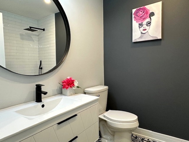 906 Revere Road Glenview, IL 60025 - Photo 14 of 32 a bathroom with a sink mirror and toilet