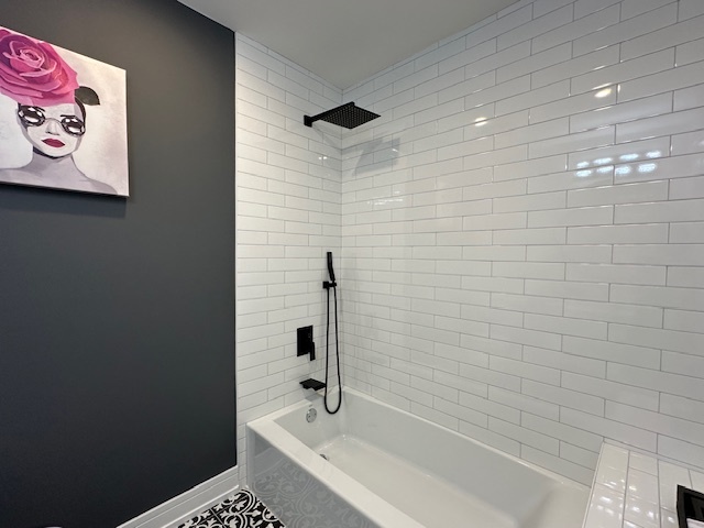 906 Revere Road Glenview, IL 60025 - Photo 15 of 32 a bathroom with a bathtub and shower