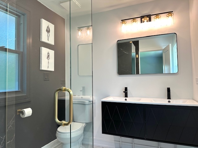 906 Revere Road Glenview, IL 60025 - Photo 17 of 32 a bathroom with a toilet sink and mirror