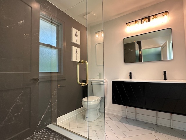 906 Revere Road Glenview, IL 60025 - Photo 19 of 32 a bathroom with a sink a toilet and mirror