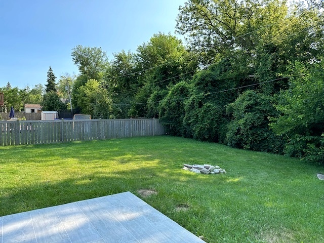 906 Revere Road Glenview, IL 60025 - Photo 30 of 32 a view of a backyard with a small cabin and wooden fence