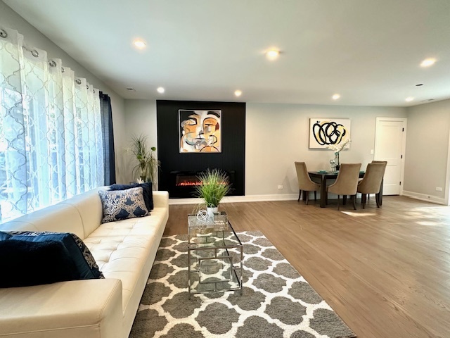 906 Revere Road Glenview, IL 60025 - Photo 9 of 32 a living room with furniture and a fireplace