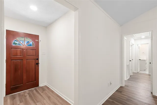 a view of a hallway with wooden floor