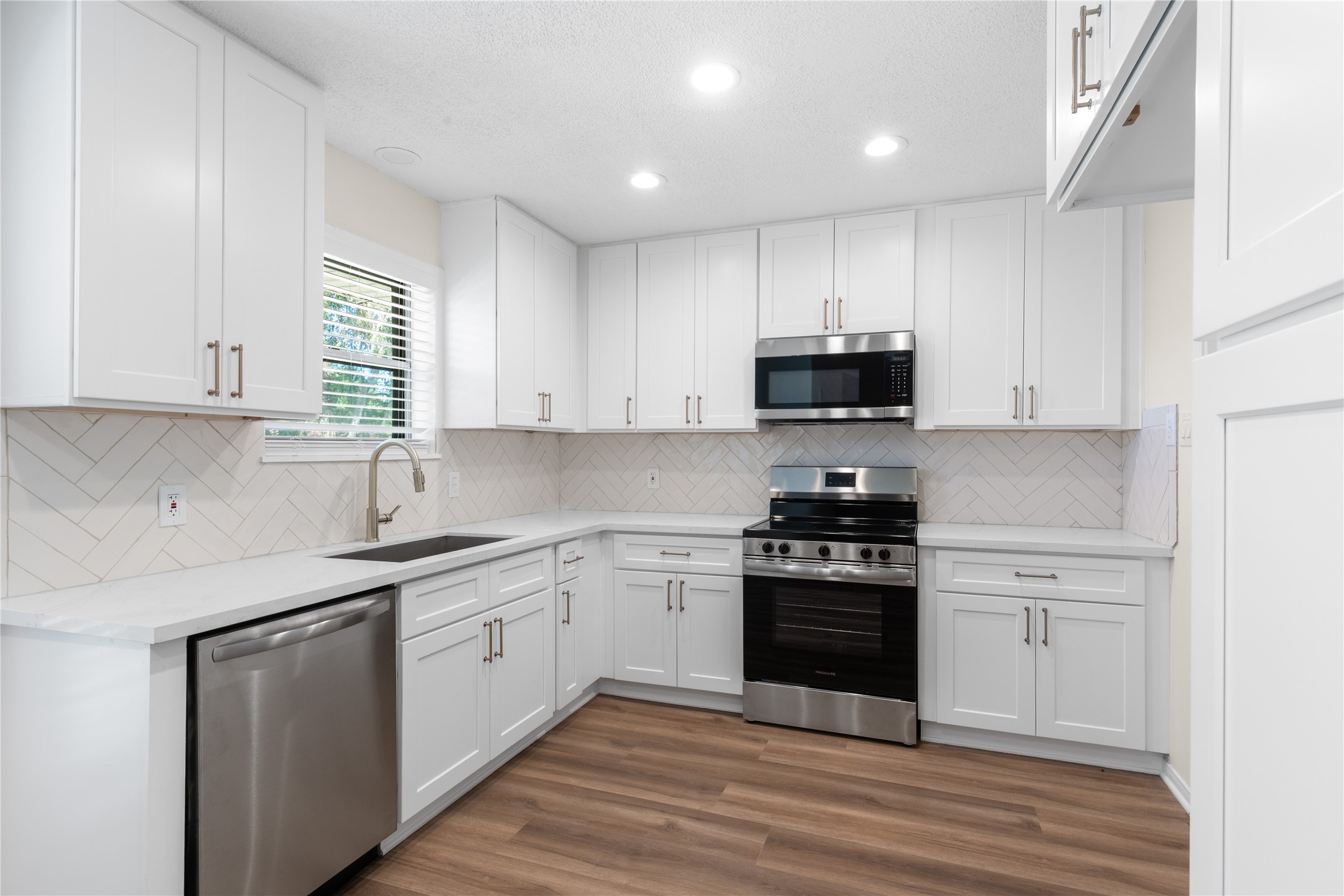 907 Avenue B Sweeny, TX 77480 - Photo 10 of 23 All new cabinets, quartz countertops, appliances, tile backsplash!