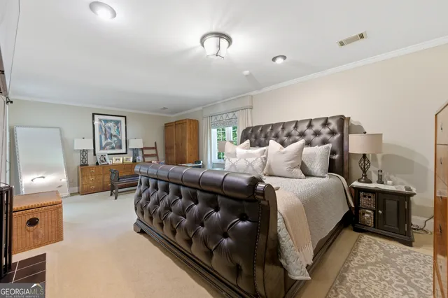 a large bedroom with a bed and window