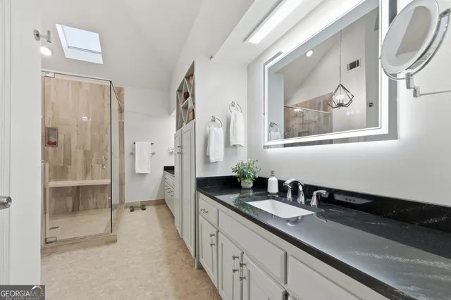 a spacious bathroom with a double vanity sink and a mirror