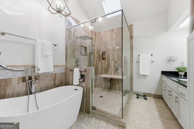 a bathroom with a bathtub a toilet and a shower