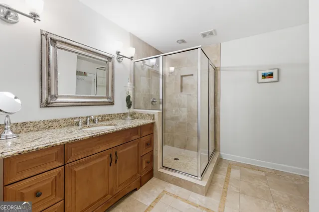 a bathroom with a shower sink and mirror
