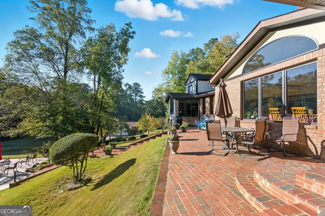 a view of a patio with couches chairs and a potted plant
