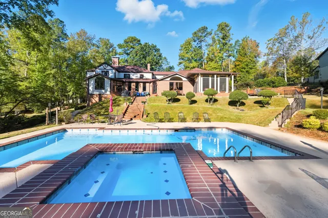 a view of swimming pool with outdoor seating
