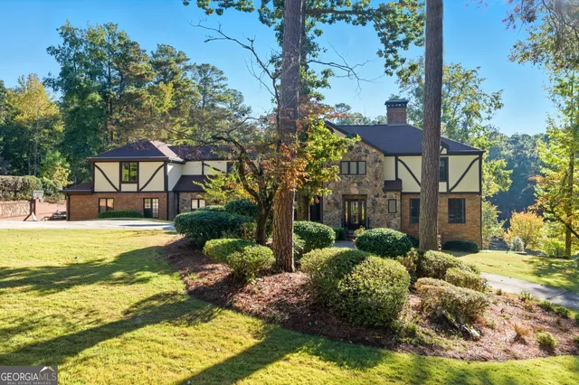 a front view of house with yard and trees