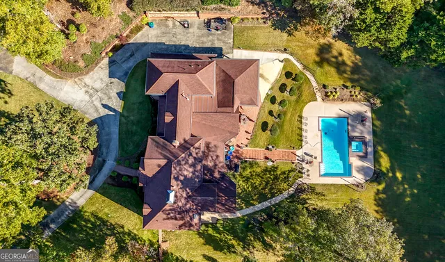 an aerial view of a house with a yard