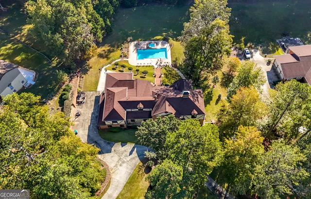 an aerial view of a house with a yard and garden
