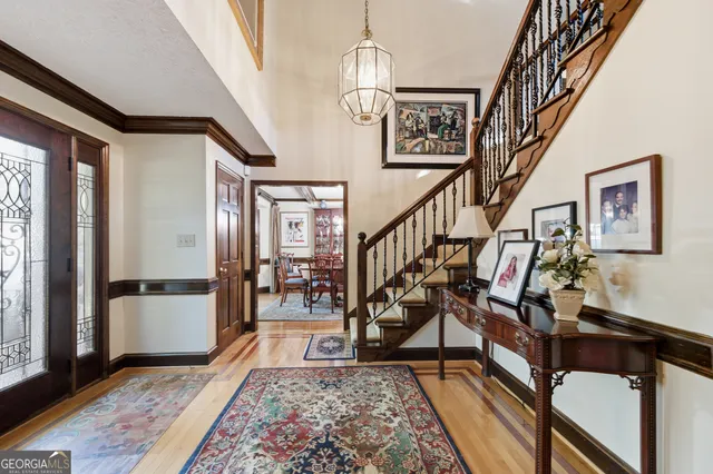a view of an entryway wooden floor and a livingroom