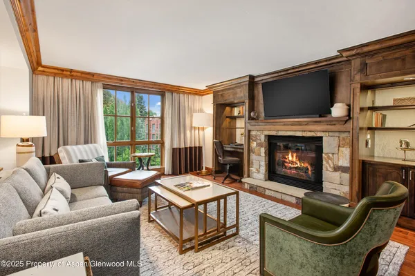 a living room with furniture flat screen tv and a fireplace