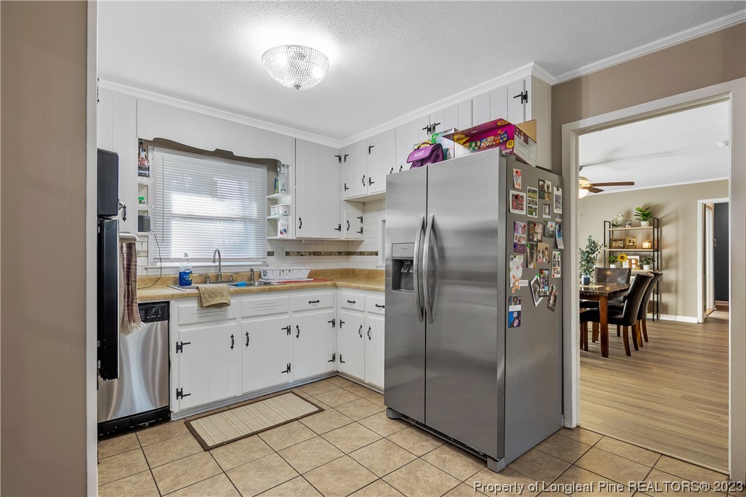6433 Milford Road Fayetteville, NC 28303 - Photo 19 of 46 a kitchen with stainless steel appliances granite countertop a refrigerator and a sink