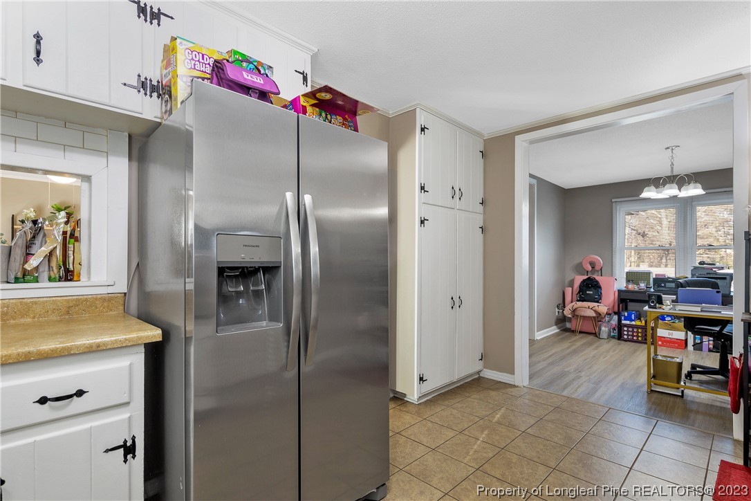 6433 Milford Road Fayetteville, NC 28303 - Photo 20 of 46 a kitchen with refrigerator and cabinets