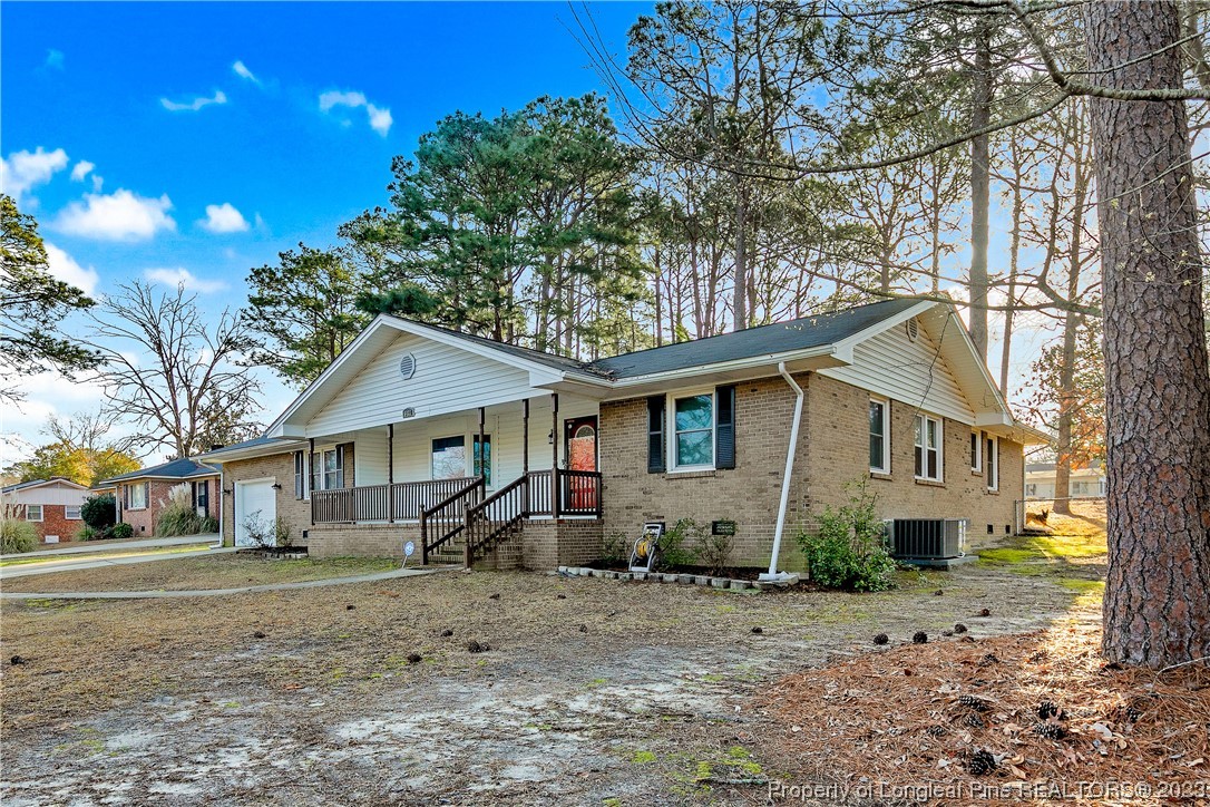 6433 Milford Road Fayetteville, NC 28303 - Photo 2 of 46 a view of a yard in front of a house with large trees