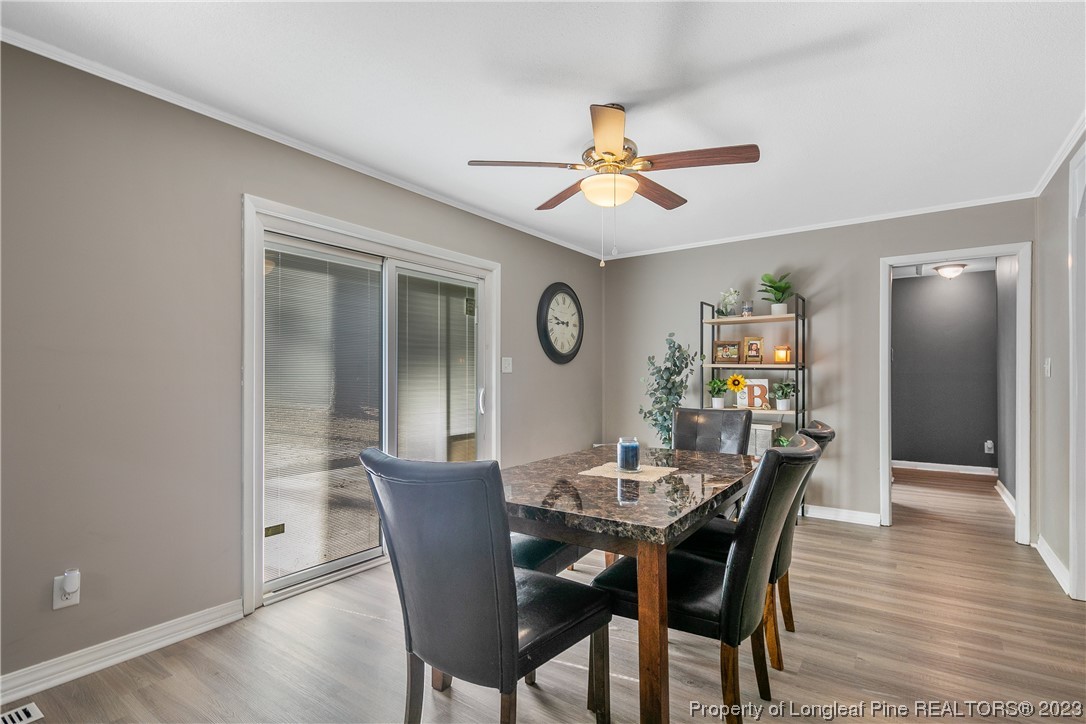 6433 Milford Road Fayetteville, NC 28303 - Photo 23 of 46 a view of a dining room with furniture window and wooden floor