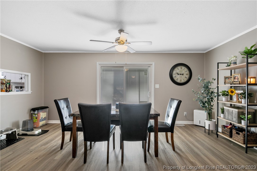 6433 Milford Road Fayetteville, NC 28303 - Photo 24 of 46 a view of a dining room with furniture and wooden floor