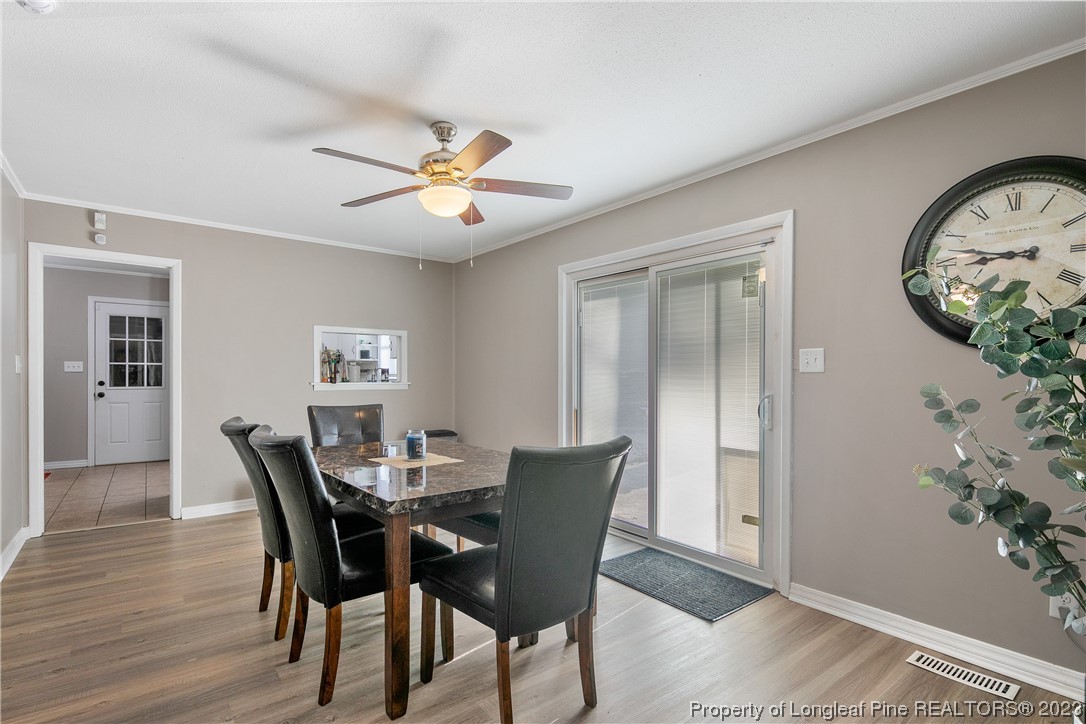 6433 Milford Road Fayetteville, NC 28303 - Photo 25 of 46 a view of a dining room with furniture and wooden floor
