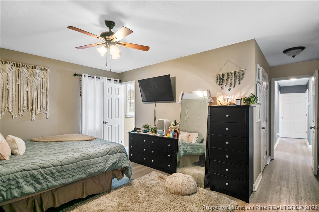 6433 Milford Road Fayetteville, NC 28303 - Photo 29 of 46 a bedroom with a bed and a mirror on dresser